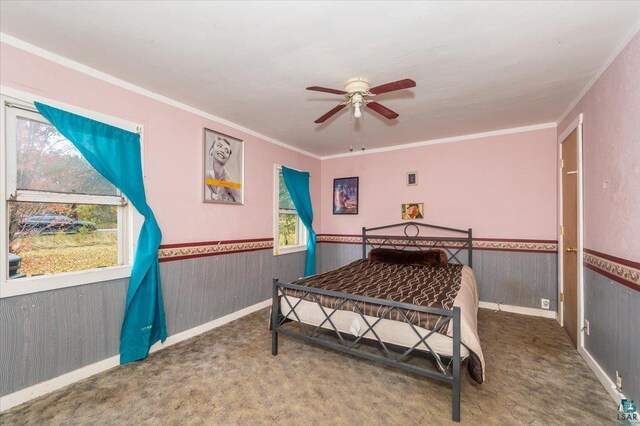 6275 S County Rd A, Superior, WI 54880 - carpeted bedroom featuring a ceiling fan, crown molding, wainscoting, and wood walls