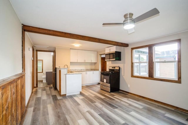 kitchen with white cabinets, ceiling fan, stainless steel appliances, and light hardwood / wood-style flooring