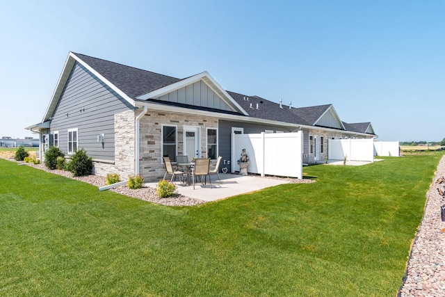 back of property featuring a yard and a patio