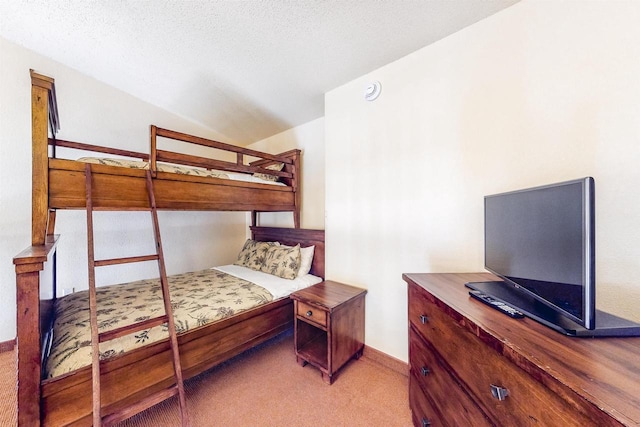 bedroom featuring a textured ceiling and carpet flooring