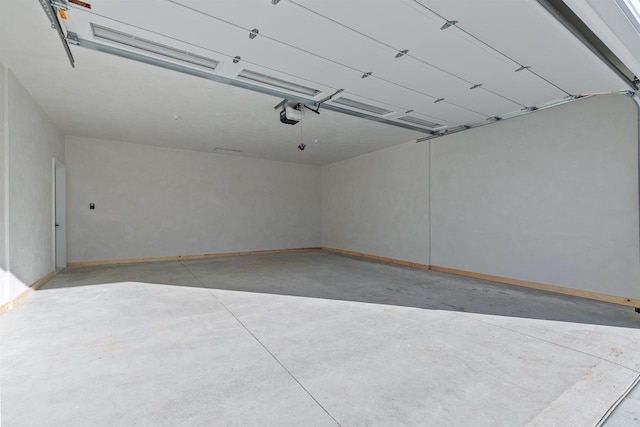 garage featuring baseboards and a garage door opener