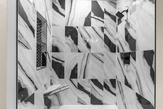 room details featuring a marble finish shower