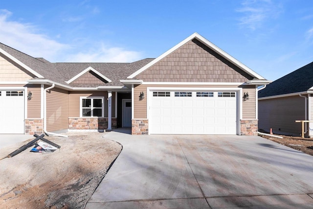 craftsman-style house featuring driveway, stone siding, roof with shingles, and an attached garage