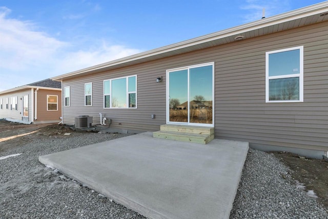 rear view of house featuring entry steps and cooling unit