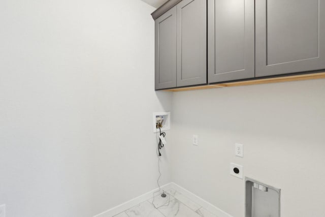 clothes washing area featuring electric dryer hookup, hookup for a washing machine, and cabinets