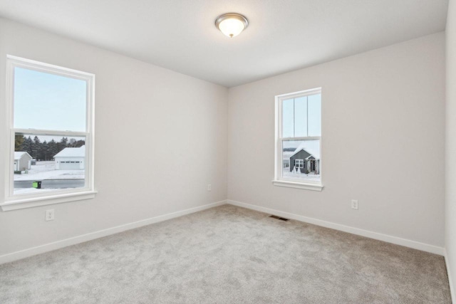 spare room with light colored carpet