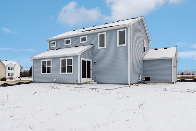 snow covered property with cooling unit