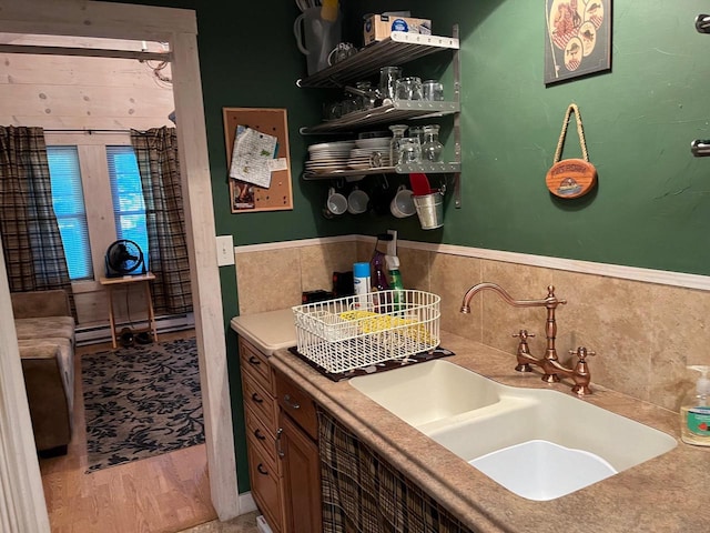 bathroom with vanity, baseboard heating, and hardwood / wood-style flooring