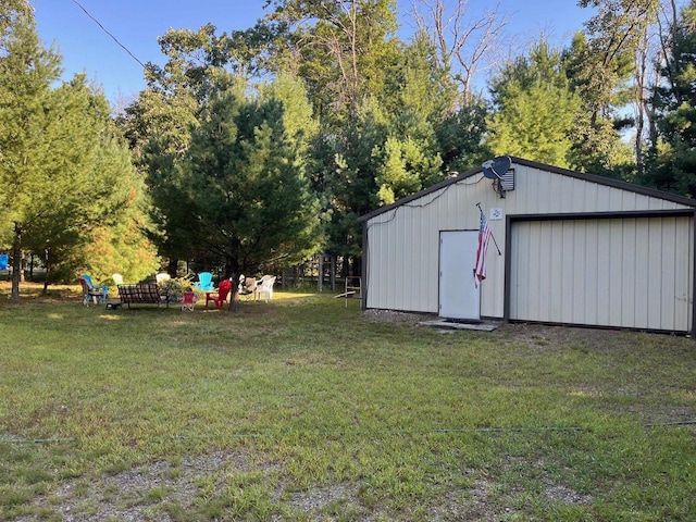 view of outdoor structure with a garage and a lawn