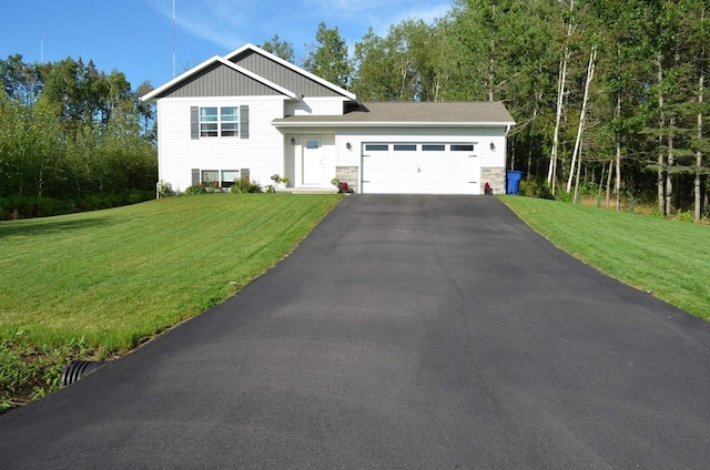 view of front of property with a garage and a front lawn