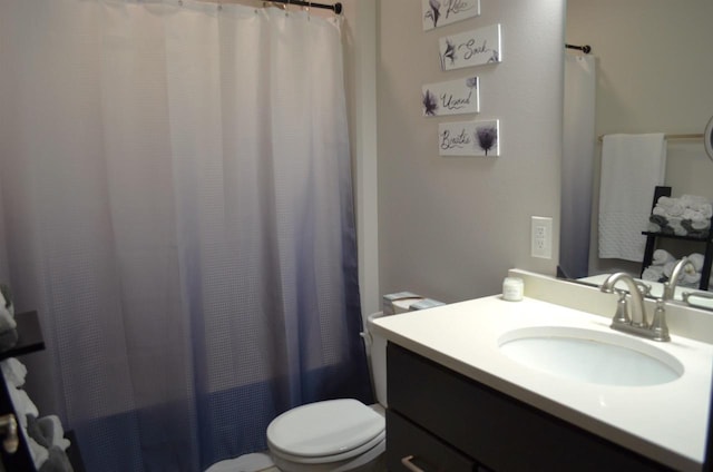 bathroom featuring vanity, toilet, and a shower with shower curtain