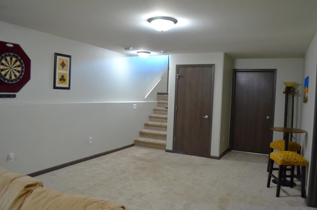 basement featuring light colored carpet