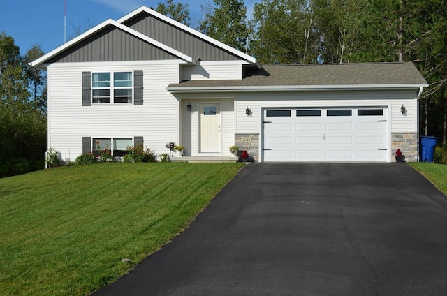 tri-level home featuring a garage and a front lawn