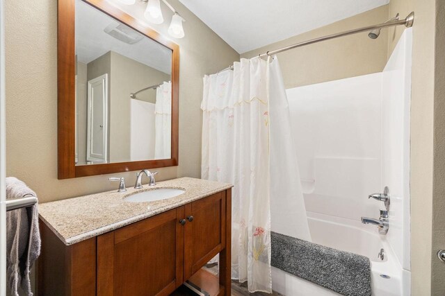 bathroom featuring shower / tub combo, visible vents, and vanity