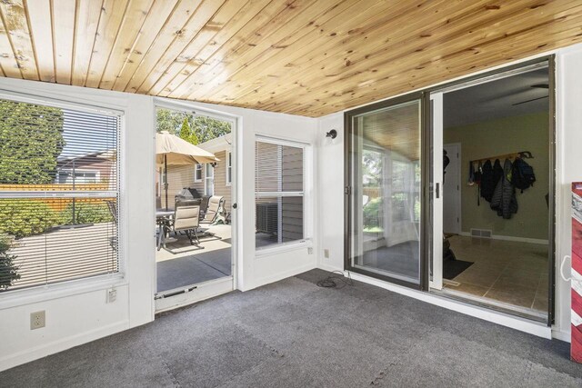 sunroom featuring wood ceiling and visible vents