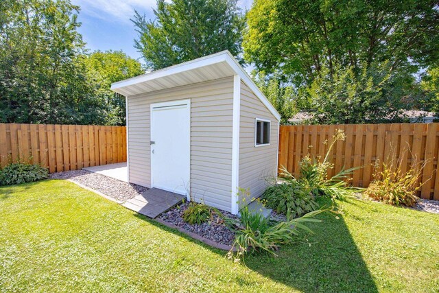 view of shed with a fenced backyard