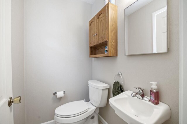 half bathroom with a sink and toilet