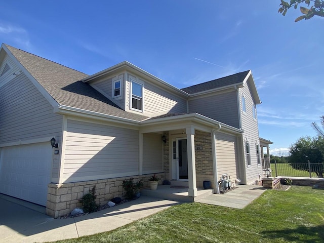 view of front facade with a front yard and a garage