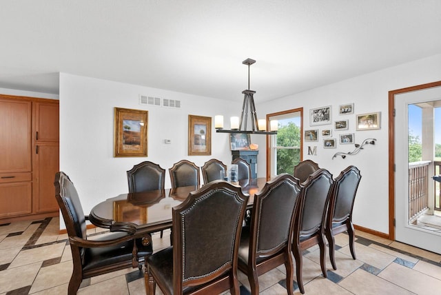 dining space featuring an inviting chandelier and light tile patterned flooring