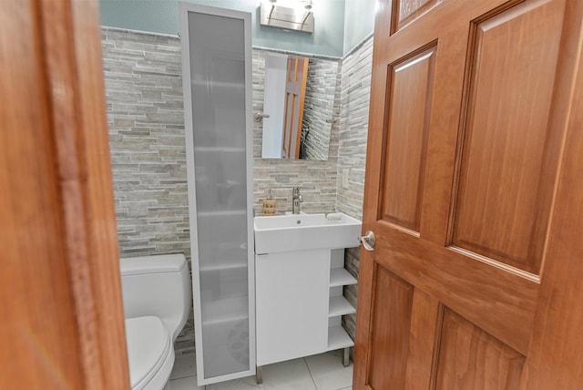 bathroom with vanity, toilet, walk in shower, and tile patterned floors