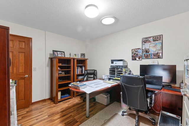 office space featuring a textured ceiling and hardwood / wood-style floors