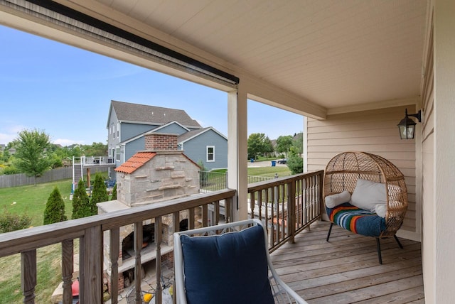 wooden deck with a yard and a fireplace