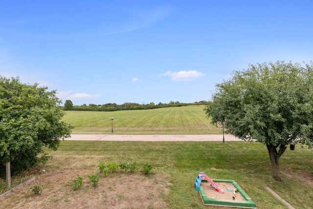 surrounding community featuring a yard and a rural view