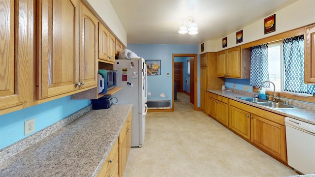 kitchen featuring white appliances and sink