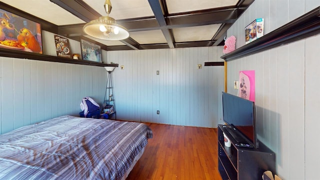 bedroom featuring wood walls, beamed ceiling, coffered ceiling, and hardwood / wood-style flooring