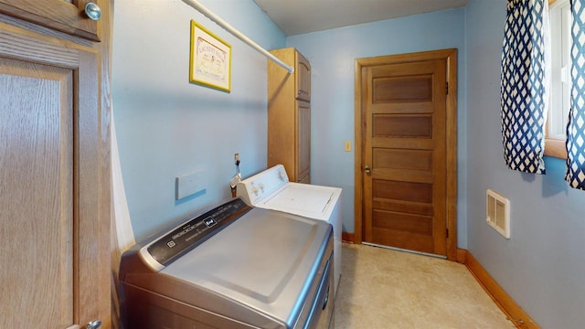 clothes washing area with washing machine and dryer