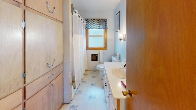 bathroom featuring vanity, toilet, and curtained shower