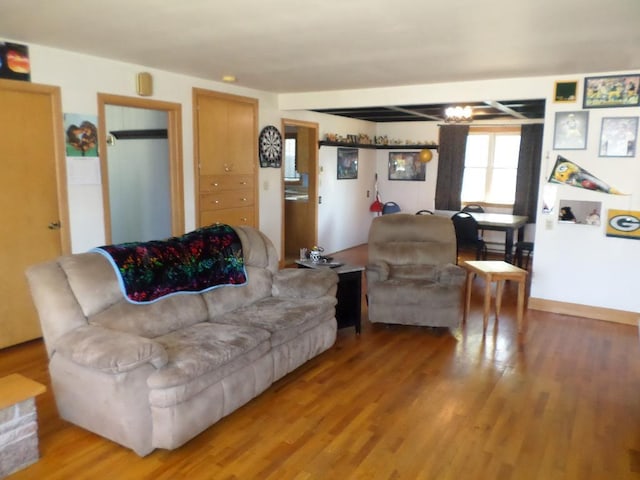 living room featuring a notable chandelier and hardwood / wood-style flooring