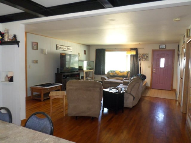 living room with wood-type flooring and beam ceiling