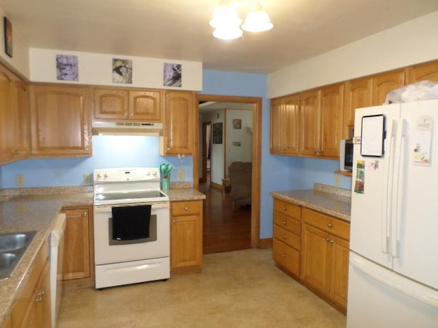 kitchen with sink, white appliances, and light hardwood / wood-style flooring