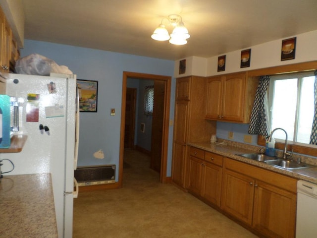 kitchen with white appliances, sink, and a chandelier