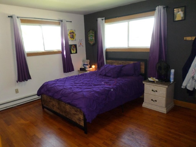 bedroom featuring baseboard heating and dark wood-type flooring