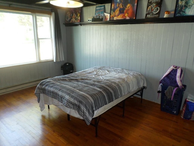 bedroom with wood-type flooring and ceiling fan