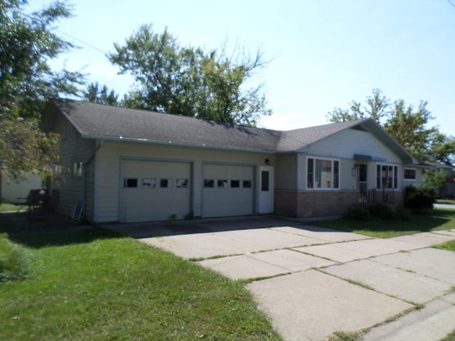 ranch-style house featuring a garage and a front yard