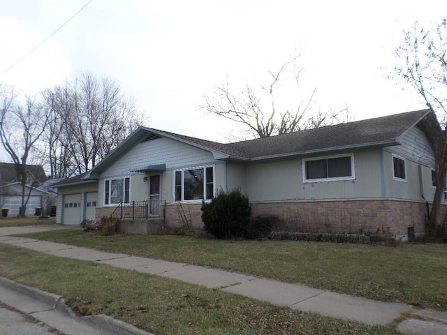 ranch-style home with a garage and a front yard