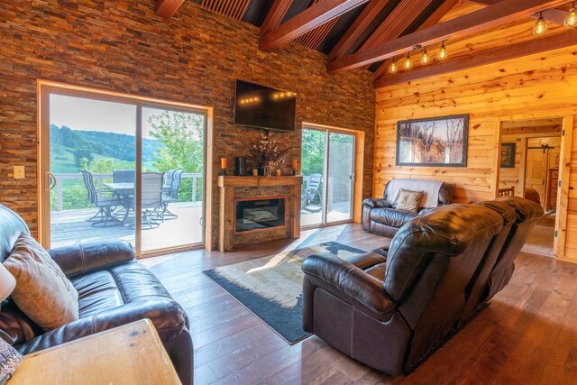 bedroom with wood walls, ceiling fan, a barn door, and carpet floors