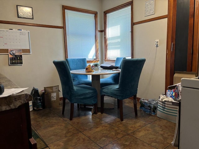 dining room featuring dark tile patterned floors