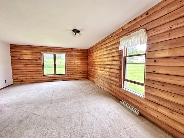 unfurnished room featuring a healthy amount of sunlight, a baseboard radiator, and light colored carpet