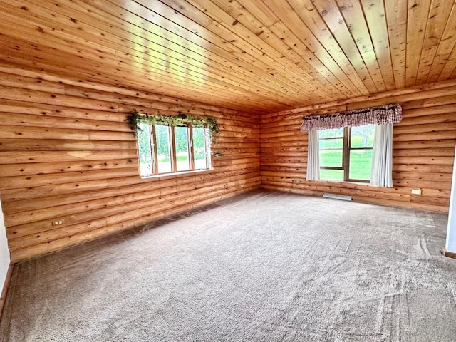 unfurnished room with rustic walls, wood ceiling, carpet floors, and a healthy amount of sunlight