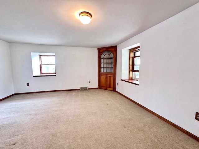 spare room with light colored carpet