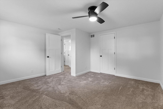 unfurnished bedroom featuring carpet floors, a closet, visible vents, ceiling fan, and baseboards