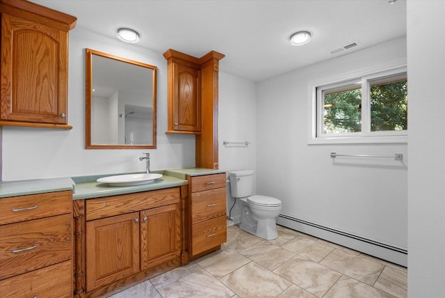 bathroom with toilet, a baseboard radiator, vanity, and visible vents