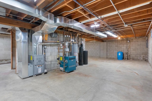 unfinished below grade area with gas water heater, a heating unit, and heating unit