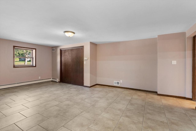 spare room featuring light tile patterned floors, baseboard heating, visible vents, and baseboards