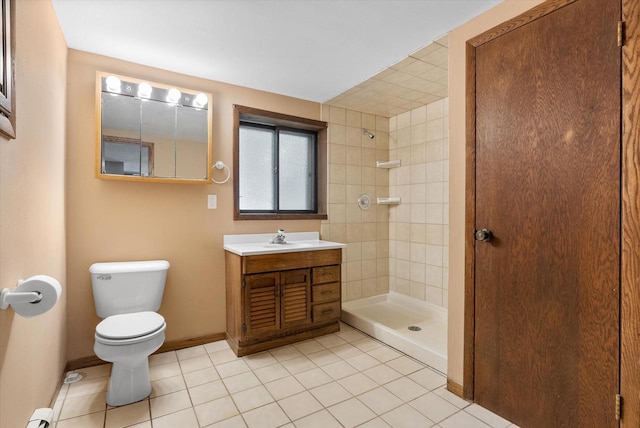 full bathroom with toilet, tile patterned flooring, a tile shower, and vanity