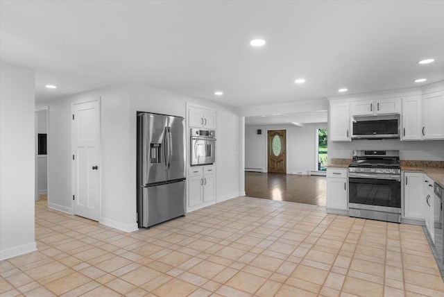 kitchen with a baseboard radiator, white cabinetry, stainless steel appliances, and recessed lighting